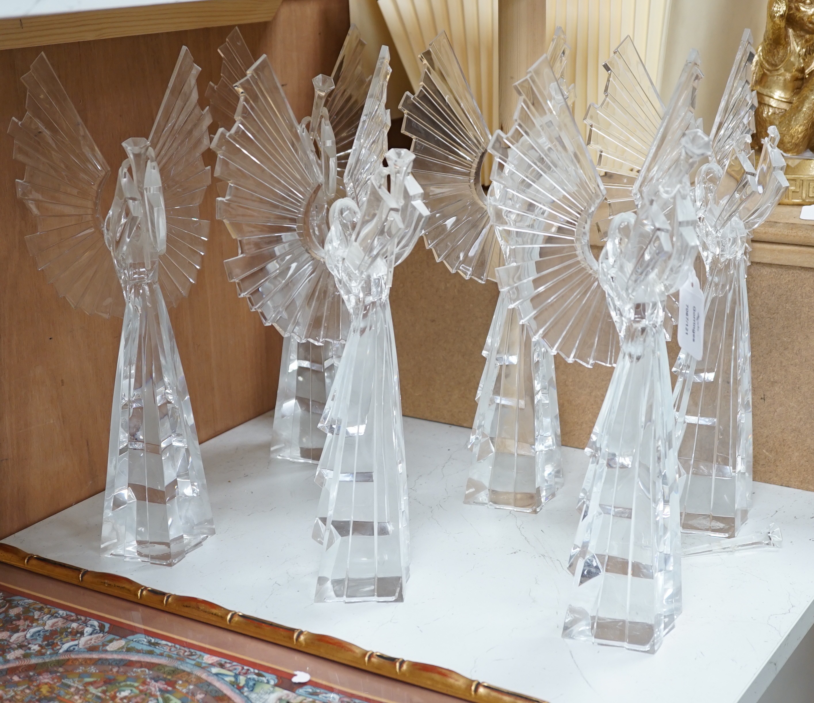 A set of six clear resin trumpeting arch-angels. 40cm tall.